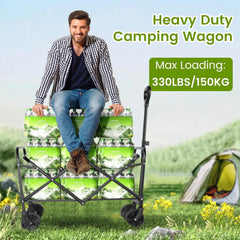 A man sits on a foldable camping wagon loaded with stacks of water bottles in a grassy field.