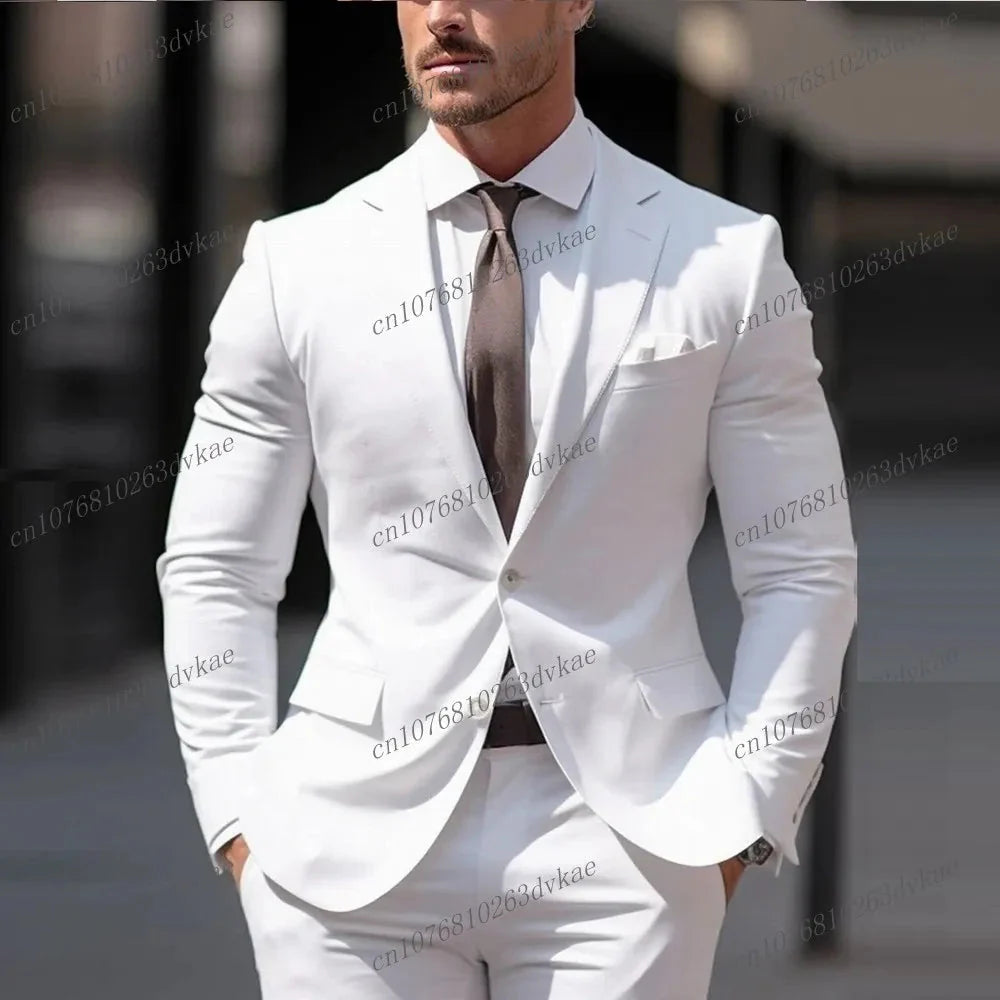 A man wears a white two-piece suit with a brown tie for a formal occasion.