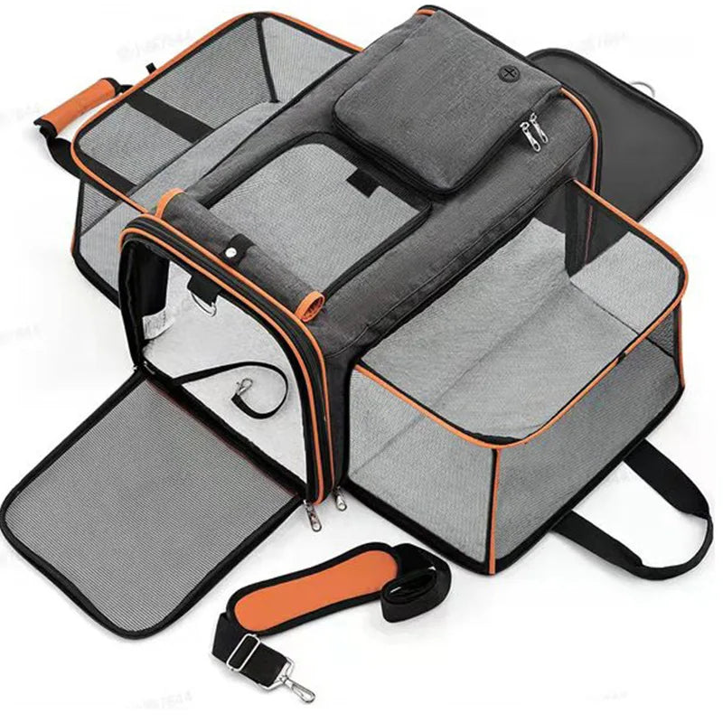A grey and orange foldable pet carrier with mesh windows and a detachable shoulder strap.