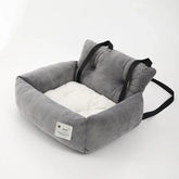 A grey and white plush car pet seat with black adjustable straps on a white background.