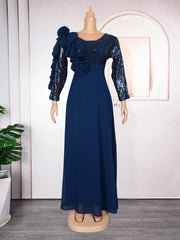 A navy blue floor-length maxi dress with sequined long sleeves and floral shoulder embellishments.