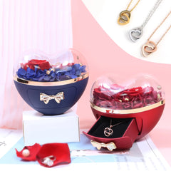 Two heart-shaped jewelry boxes with preserved flowers and a matching necklace.