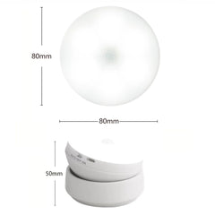A round white motion sensor night light shown from top and side views with dimensions.