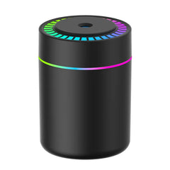 A black cylindrical aromatherapy essential oil diffuser with a colorful LED light ring.
