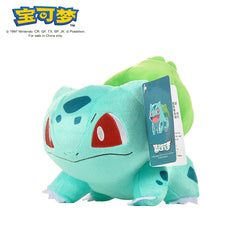 A plush Bulbasaur toy with a green bulb on its back and an attached product tag.
