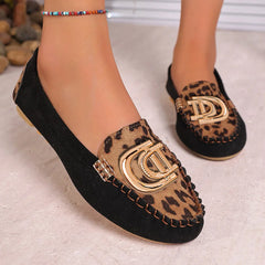 Women's black suede loafers featuring a leopard print panel and a gold-tone metal buckle.