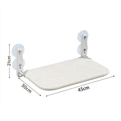 A cat hammock with a beige fabric bed and white supports that attach to glass via suction cups.
