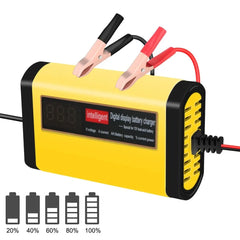 A yellow portable car battery charger with a digital display and red and black alligator clips.