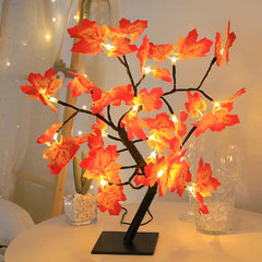 A decorative maple leaf tree lamp with warm LED lights on a black base.