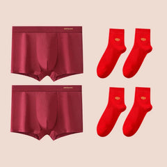 Two pairs of red cotton boxer shorts and two pairs of matching red socks.