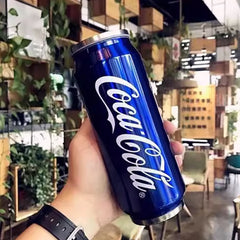 A blue stainless steel Coca-Cola branded tumbler held in a hand.