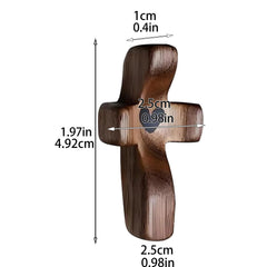 A small, smooth wooden pocket cross with a heart cutout, shown with its dimensions in centimeters.