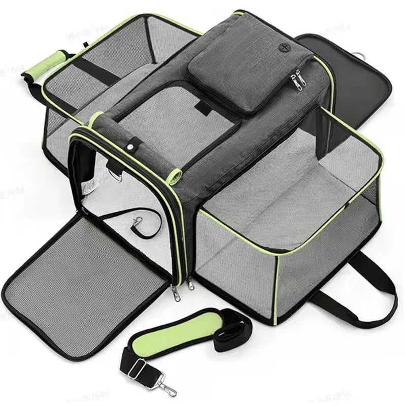 A grey, soft-sided pet carrier with expandable mesh sides and a detachable shoulder strap.