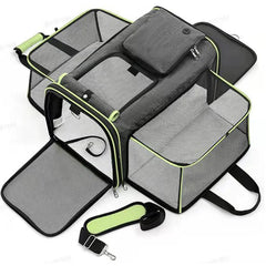 A grey, soft-sided pet carrier with expandable mesh sides and a detachable shoulder strap.