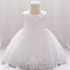 A sleeveless white baby dress featuring floral lace embroidery and a full tulle skirt.