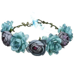 A floral crown featuring artificial blue and grey roses with a blue ribbon tie at the back.