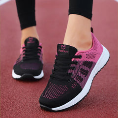 A pair of black and pink breathable mesh lace-up sneakers with white platform soles.