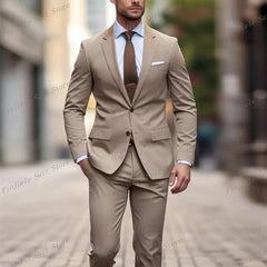 A man wearing a two-piece brown business suit with a light blue shirt and brown tie.