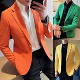 Three men wearing slim-fit blazers in orange, green, and yellow over shirts and dark trousers.