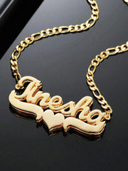 A gold-plated stainless steel nameplate necklace featuring the name Anesha and a heart symbol.