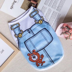 A light blue dog tank top featuring a cartoon bear print and overall-style straps.