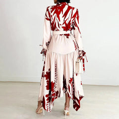 A woman wears an ankle-length, long-sleeved dress with a red and white floral print.