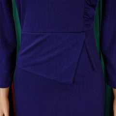 A close-up of a solid purple long-sleeved sheath dress featuring a draped waist detail.