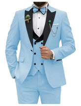 A light blue three-piece suit featuring a black peak lapel, vest, and matching bow tie.