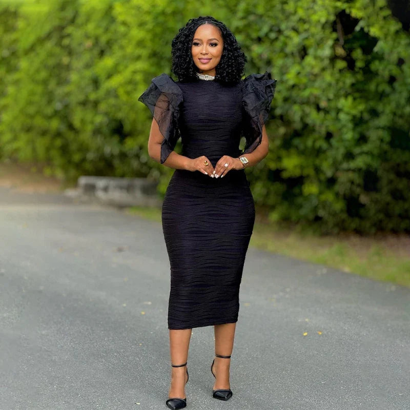 A woman wears a black midi-length bodycon dress with ruffled butterfly sleeves and a round neckline.