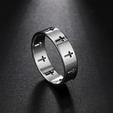A silver-colored stainless steel ring featuring a repeating cutout cross pattern.