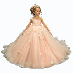 A young girl wears a floor-length, sleeveless pink tulle ball gown with 3D floral appliques.