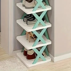 A four-tier white shoe rack with light green X-shaped side supports standing in a corner.