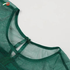A close-up view of the dark green sheer mesh neckline on an elegant African-style dress.