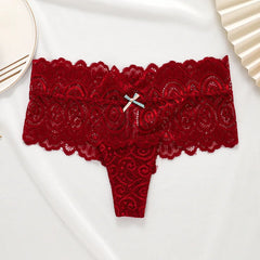 A red low-waist lace thong featuring a small decorative bow at the center front.
