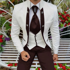 A man wears a white patterned jacket with dark brown lapels, a white vest, and dark brown trousers.