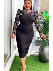 A woman wears a black midi dress with sheer long sleeves featuring white floral embroidery.