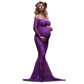 A pregnant woman wears a long-sleeved, purple lace mermaid-style maternity gown for a photoshoot.