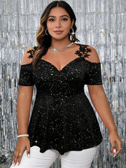 A plus size black glittery cold shoulder peplum top with lace floral accents on the shoulders.