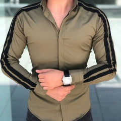 A tan long-sleeve button-up shirt featuring black stripes running down the shoulders and sleeves.