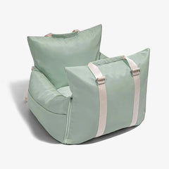 A sage green waterproof pet car seat with light-colored straps on a white background.