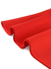 A close-up view of the smooth, vibrant red fabric of a mid-calf evening dress.