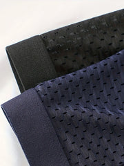 A close-up view of black and navy blue ice silk mesh boxer shorts with elastic waistbands.