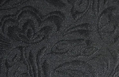 Close-up of a black fabric with a subtle, tone-on-tone floral jacquard pattern.