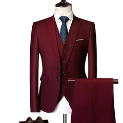 A three-piece burgundy suit featuring a single-breasted jacket, vest, and matching trousers.