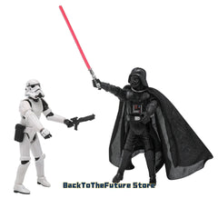A Darth Vader action figure holding a red lightsaber stands opposite a Stormtrooper with a blaster.