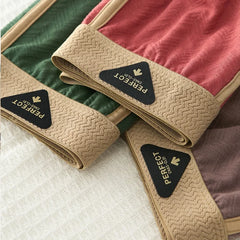 Three pairs of men's cotton boxer shorts in green, red, and brown with textured elastic waistbands.