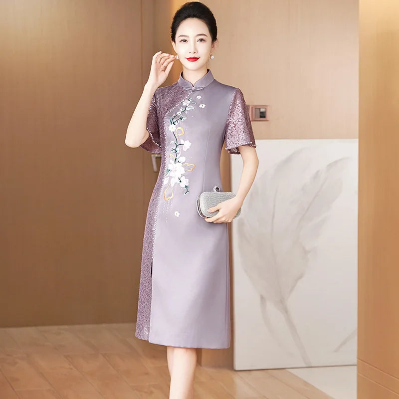 A woman wears an elegant purple satin cheongsam with floral embroidery and lace sleeve details.