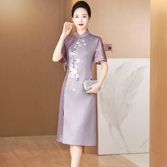 A woman wears an elegant purple satin cheongsam with floral embroidery and lace sleeve details.