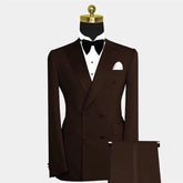 A brown double-breasted suit with a peak lapel, white dress shirt, and black bow tie.