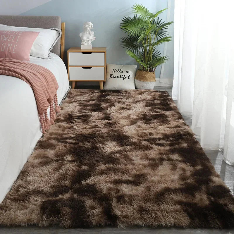A rectangular, plush brown shag rug with a tie-dye effect placed on a bedroom floor.